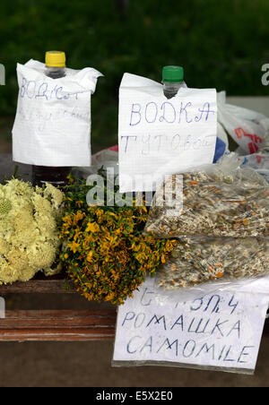 Herbs and vodka are offered at the Tatew monastery of the Armenian Apostolic Church in the south of Armenia in Tatev, Armenia, 24 June 2014. It is one of the countrie's most importants architectural memorials. The monastery was built in the 9th century, at an old shrine. It used to be an intellectual center of Armenia and a university between 1390 and 1453. Photo: Jens Kalaene Stock Photo