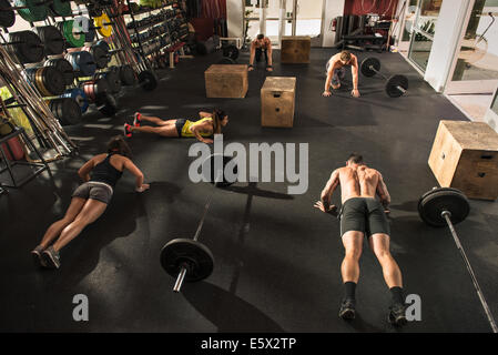 Bodybuilder doing push ups in gym Stock Photo