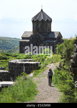 A visitor walks on a road leading towards the church of Surp Astvatsatsin (Holy Mother of God) in Ambed, Armenia, 28 June 2014. The church was built entirely of tuff in 1026 AD. Photo: Jens Kalaene/dpa - NO WIRE SERVICE - Stock Photo