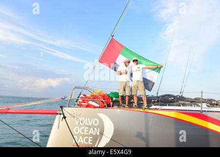 Isle of Wight, UK. 6th Aug, 2014. Abu Dhabi, makes debut at Cowes, naming of Azzam, Abu Dhabi Ocean Racing's contender of the new generation of boat, VO65 for the 2014/15 Volvo Ocean Race.The boats will arrive in Abu Dhabi on 14-15 December following their leg from Cape Town. Members of the team including Ian Walker (Skipper) right Adil Khalid (Trimmer and helmsman- under 30) left.The name Azzam means 'determination.'This was followed by races in a prize-winning day with the team on Azzam in the Artemis Challenge on a race around the Isle of Wight. Credit:  Gary Blake/Alamy Live News Stock Photo