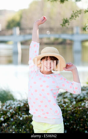 Portrait of ten year old girl with hand raised Stock Photo