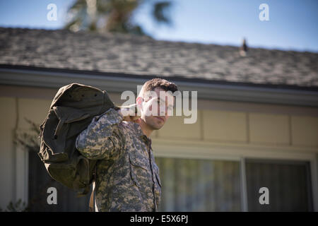 Portrait of intense looking male soldier in garden on homecoming Stock Photo