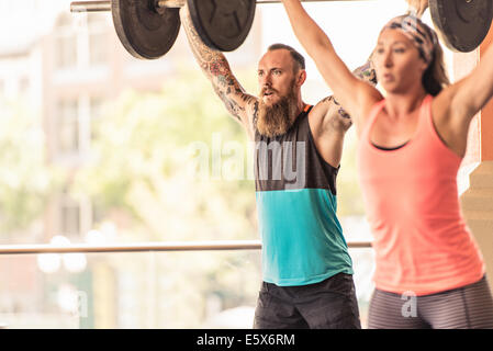 Man and woman lifting weights Stock Photo