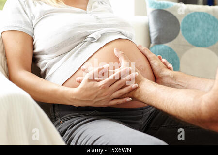 Pregnant woman sat with partner Stock Photo