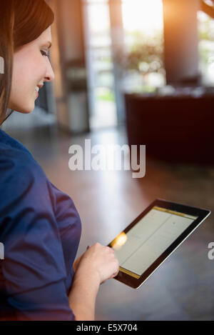Cropped view of young businesswoman using digital tablet in office Stock Photo