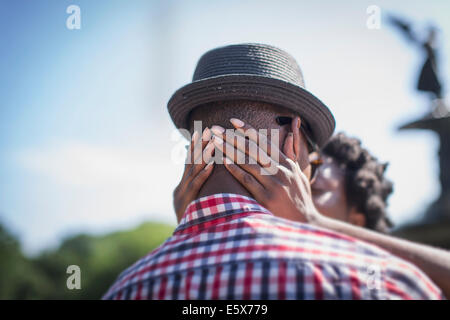 Close up of young couple kissing next to Bethesda fountain, Central Park, New York City, USA Stock Photo
