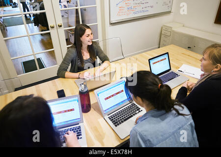 Female colleagues in a meeting with laptops Stock Photo
