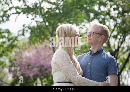 Young couple embracing in park Stock Photo