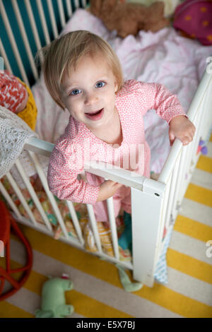 High angle portrait of female toddler in crib Stock Photo
