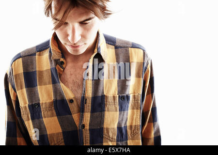 Studio portrait of young man looking down Stock Photo