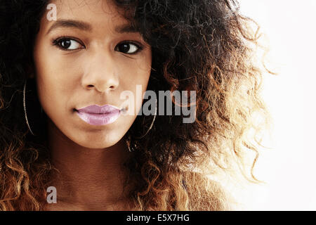 Close up studio portrait of young woman glancing sideways Stock Photo
