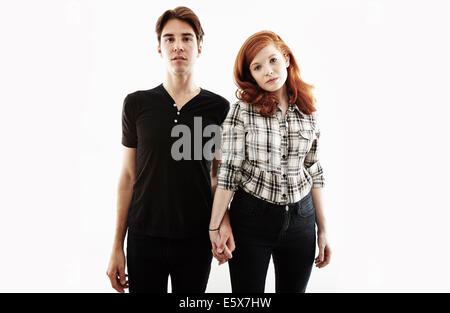 Studio portrait of bored looking young couple