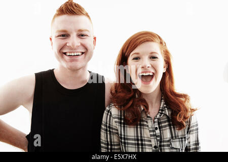 Studio portrait of red haired young couple laughing Stock Photo