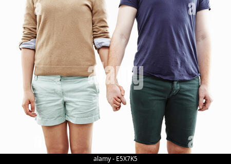 Studio cropped shot of young couple holding hands Stock Photo