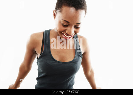 Studio shot of smiling young woman looking down Stock Photo
