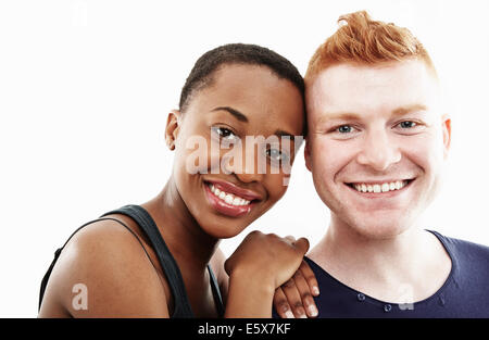 Studio portrait of smiling young couple Stock Photo