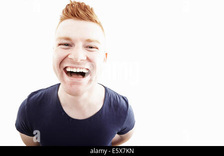 Studio portrait of young man laughing Stock Photo