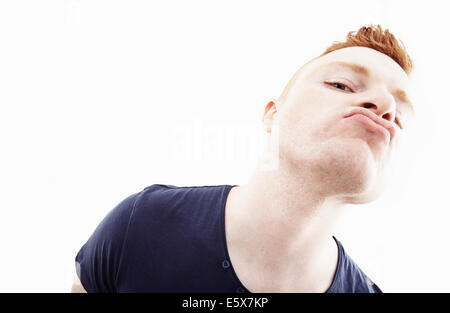 Studio portrait of young man pulling a face Stock Photo