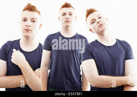 Three time multi exposure of young man staring Stock Photo