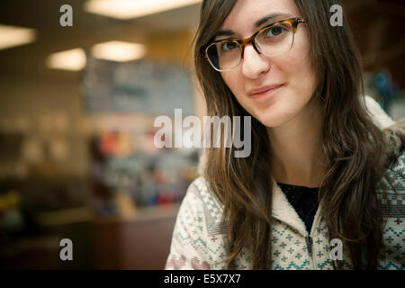 Close up portrait of mid adult woman in cafe