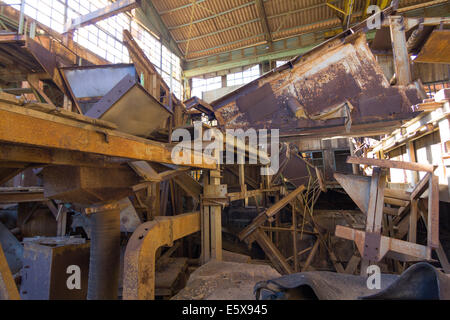 machinery destroyed in a coal mine abandoned after the war Stock Photo