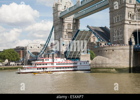 Tower Bridge with middle section raised and tourist steam boat, Dixie Queen, passing through Stock Photo