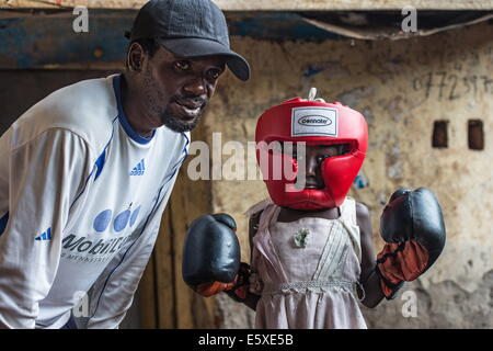 Kampala, Uganda. 10th Dec, 2013. KAPALATA INNOCENT an experienced trainer and former boxer is training a young girl. © Johan Bauza/ZUMA Wire/ZUMAPRESS.com/Alamy Live News Stock Photo