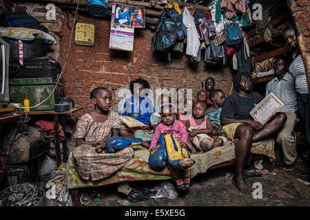 Kampala, Uganda. 10th Dec, 2013. Helene and Diana live with more than 25 relatives in 20 square meters with no windows, sharing the space with livestock, sleeping in bunk beds and on the floor. © Johan Bauza/ZUMA Wire/ZUMAPRESS.com/Alamy Live News Stock Photo