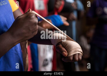 Kampala, Uganda. 10th Dec, 2013. Those who are lucky enough to be members of the club, have just the basic gear, wrinkled, worn and shared gloves, dirty bandages and no modern training methods. © Johan Bauza/ZUMA Wire/ZUMAPRESS.com/Alamy Live News Stock Photo