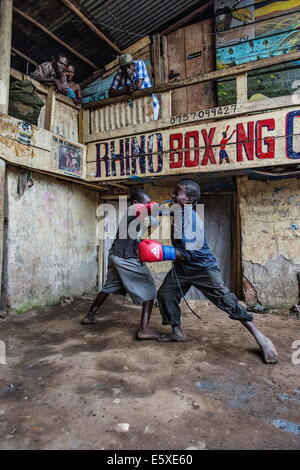 Kampala, Uganda. 10th Dec, 2013. The two sisters encourage 2 young boys to train and fight hard. © Johan Bauza/ZUMA Wire/ZUMAPRESS.com/Alamy Live News Stock Photo