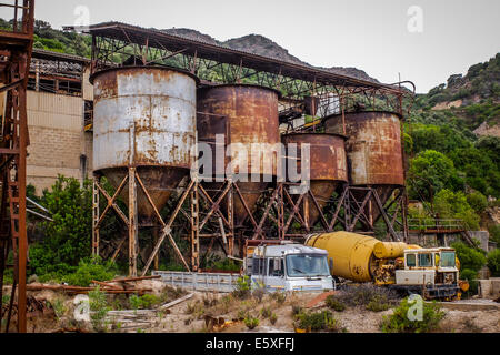 The coal mine of Santa Lucia, in the inner Sardinia (Italy),  abandoned in the Eighties and now rusty. Stock Photo