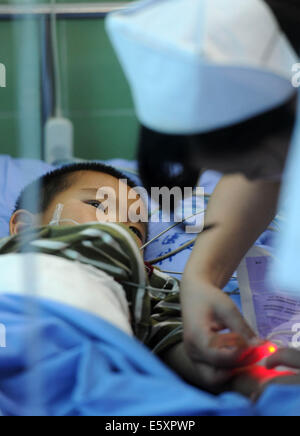 Yibin. 8th Aug, 2014. Li Ruiyang, a three-year-old boy who was injured in the recent Yunnan earthquake, receives treatment at the Second People's Hospital in Yibin City, southwest China's Sichuan Province, Aug. 7, 2014. Some of the people injured in the Yunnan earthquake were receiving treatment in Sichuan's Yibin. Credit:  Xinhua/Alamy Live News Stock Photo