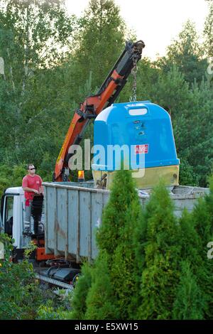 collecting of separated waste bin with hydraulic crane Stock Photo