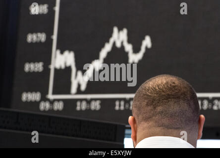 Frankfurt Main, Germany. 08th Aug, 2014. The stock brokers watch the stock market development on the national and international markets on the floor of the stock market in Frankfurt Main, Germany, 08 August 2014. The German stock index DAX slipped under the 9000 point mark this morning. Photo: BORIS ROESSLER/dpa/Alamy Live News Stock Photo