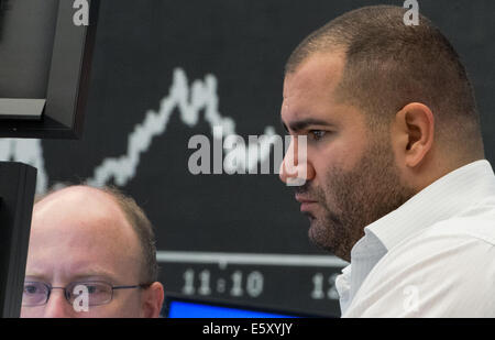 Frankfurt Main, Germany. 08th Aug, 2014. The stock brokers watch the stock market development on the national and international markets on the floor of the stock market in Frankfurt Main, Germany, 08 August 2014. The German stock index DAX slipped under the 9000 point mark this morning. Photo: BORIS ROESSLER/dpa/Alamy Live News Stock Photo