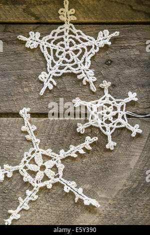 Antique lace Christmas ornaments on old wood plank Stock Photo