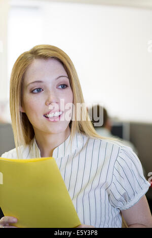 Office worker holding file folder Stock Photo