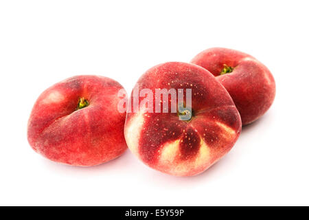 Three Donut (Doughnut), Paraguayo, Saturn or Flat peaches isolated on a white background. Stock Photo
