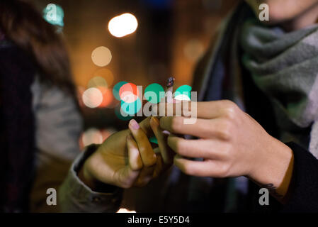 Friends passing joint Stock Photo