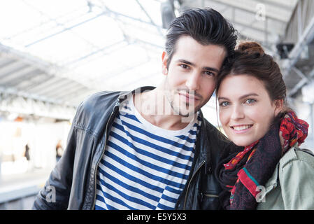 Young couple together on train platform, portrait Stock Photo