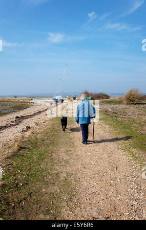 Senior woman walking a dog Stock Photo