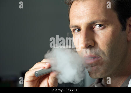 Man smoking electonic cigarette Stock Photo