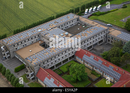 Photovoltaic solar panels on roof providing electricity by sun energy to office buildings Stock Photo