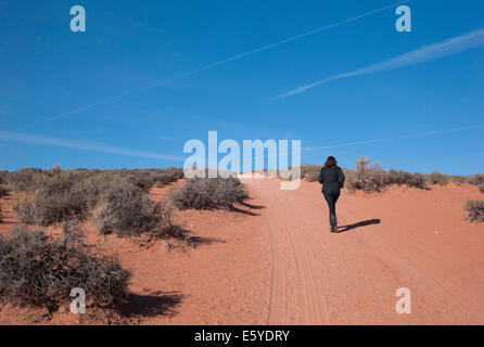 Woman walking in a desert, Horseshoe Bend, Glen Canyon National Recreation Area, Arizona-Utah, USA Stock Photo