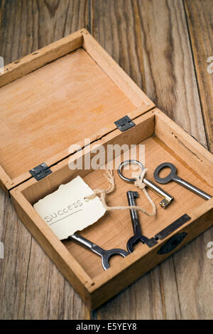 Wooden box containing the key to success Stock Photo