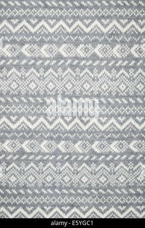 Knit fabric background with knitted grey and white geometric pattern Stock Photo