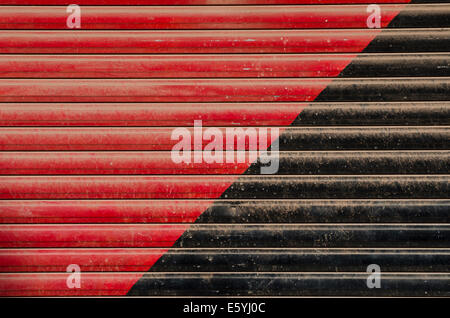 metal door red and black painted grunge corrugated background Stock Photo