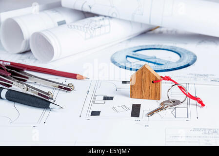 Architect worplace with blueprints, tools and house key Stock Photo