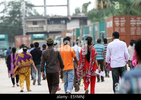 Garment workers are in a long queue to join their workplace in Ashulia in Dhaka on August 9, 2014 Stock Photo