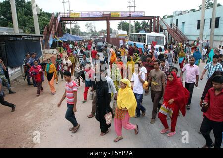 Garment workers are in a long queue to join their workplace in Ashulia in Dhaka on August 9, 2014 Stock Photo